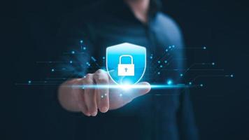Cybersecurity concept, personal data protection and network security. Businessman touching key protecting business and financial data on tablet, secure internet access, security encryption. photo