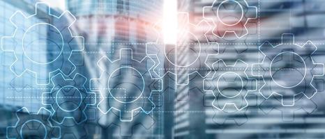 Double exposure gears mechanism on blurred background. Business and industrial process automation concept. photo