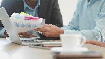 Financial analysts analyze business financial reports on a digital tablet planning investment project during a discussion at a meeting of corporate showing the results of their successful teamwork. video