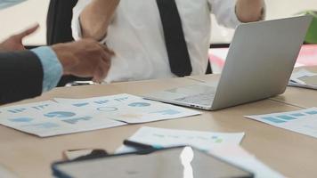 Financial analysts analyze business financial reports on a digital tablet planning investment project during a discussion at a meeting of corporate showing the results of their successful teamwork. video