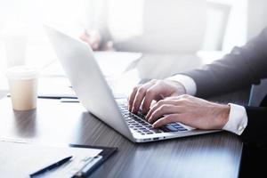 Man working on a laptop. Concept of internet sharing and interconnection photo