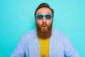 Man with beard and sunglasses is wondered and happy photo