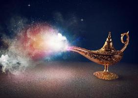 Smoke exists from magic aladdin genie lamp in a desert photo