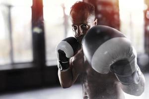 Man does boxing workouts at the gym photo