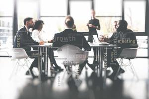 Background concept with business people sitting at the meeting table in the office near a window glass photo