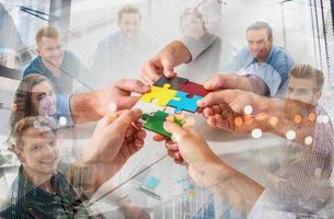 Teamwork of partners. Concept of integration and startup with puzzle pieces photo