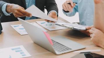Financial analysts analyze business financial reports on a digital tablet planning investment project during a discussion at a meeting of corporate showing the results of their successful teamwork. video