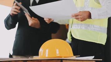 architect man working with laptop and blueprints,engineer inspection in workplace for architectural plan,sketching a construction project ,selective focus,Business concept vintage color video