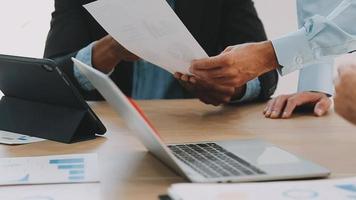 Financial analysts analyze business financial reports on a digital tablet planning investment project during a discussion at a meeting of corporate showing the results of their successful teamwork. video