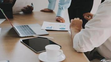 Financial analysts analyze business financial reports on a digital tablet planning investment project during a discussion at a meeting of corporate showing the results of their successful teamwork. video