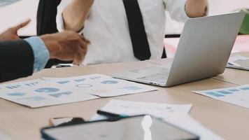 Financial analysts analyze business financial reports on a digital tablet planning investment project during a discussion at a meeting of corporate showing the results of their successful teamwork. video