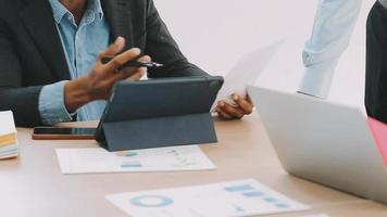 Financial analysts analyze business financial reports on a digital tablet planning investment project during a discussion at a meeting of corporate showing the results of their successful teamwork. video
