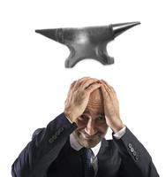 Difficult career in business with falling anvil photo