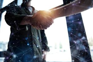 Handshaking business person in office. concept of teamwork and partnership. Internet network effect photo