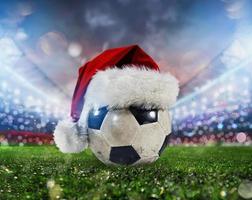 Soccer ball in a stadium with the Christmas hat photo