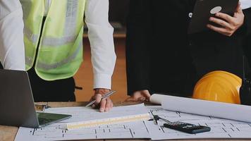 arquitecto hombre trabajando con ordenador portátil y planos, ingeniero inspección en lugar de trabajo para arquitectónico plan, bosquejo un construcción proyecto ,selectivo foco,negocio concepto Clásico color video