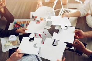 Teamwork of partners. Concept of integration and startup with puzzle pieces photo