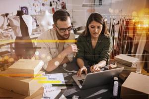 Seamstresses team ready to ship package to client with new clothes photo