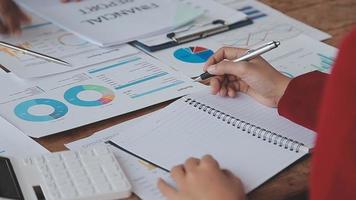 Financial analysts analyze business financial reports on a digital tablet planning investment project during a discussion at a meeting of corporate showing the results of their successful teamwork. video