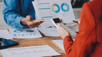 Financial analysts analyze business financial reports on a digital tablet planning investment project during a discussion at a meeting of corporate showing the results of their successful teamwork. video
