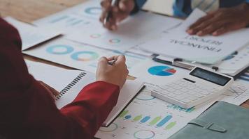 Financial analysts analyze business financial reports on a digital tablet planning investment project during a discussion at a meeting of corporate showing the results of their successful teamwork. video