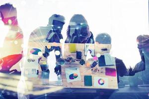 Business people work together in office with internet network effects. Concept of teamwork and partnership. double exposure photo