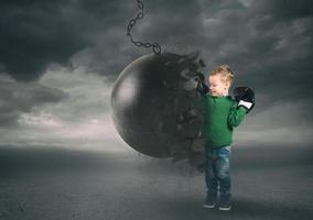 Power and determination of a child against a wrecking ball photo