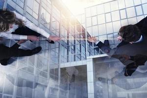 Rival business man and woman compete for the command by pulling the rope. double exposure photo