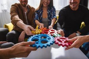 Business team connect pieces of gears. Teamwork, partnership and integration concept photo