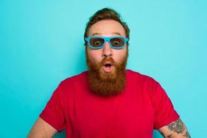 Man with beard and sunglasses is wondered and happy photo