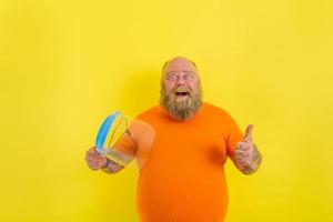 Happy man with beard and tattoos has a protective face shield against covid-19 photo