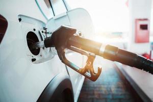 Fuel pump fill a tank of a car in a station photo