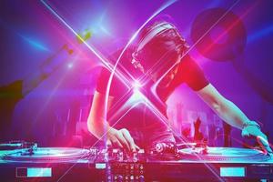 Dj plays music with a mixer at the discotheque party photo