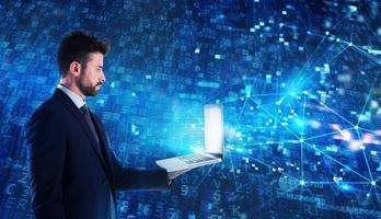 Programmer man works with a laptop on a network application photo