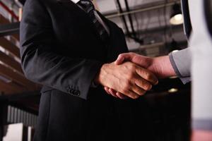 Handshaking business person in office. concept of teamwork and partnership photo