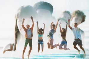 Happy smiling friends jumping at the beach. double exposure photo