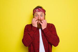 Fearful man with beard and bandana in head photo