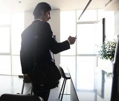 Businessman at the phone ready to travel. photo