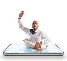 Businessman with lifebelt risks drowning on the screen of a smartphone photo