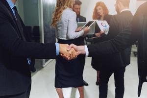 Handshaking of business person in office as teamwork and partnership photo