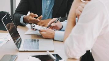 Financial analysts analyze business financial reports on a digital tablet planning investment project during a discussion at a meeting of corporate showing the results of their successful teamwork. video