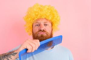 Thoughtful man with beard, yellow peruke and big comb photo