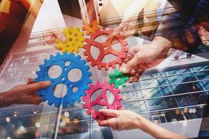 Business team connect pieces of gears like a teamwork and partners photo
