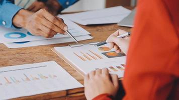 Financial analysts analyze business financial reports on a digital tablet planning investment project during a discussion at a meeting of corporate showing the results of their successful teamwork. video