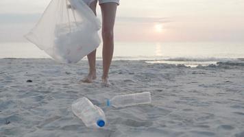 ahorrar agua. los voluntarios recogen basura en la playa y las botellas de plástico son difíciles de descomponer para evitar dañar la vida acuática. tierra, ambiente, planeta verde, reducir el calentamiento global, salvar el mundo video