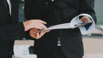 Financial analysts analyze business financial reports on a digital tablet planning investment project during a discussion at a meeting of corporate showing the results of their successful teamwork. video