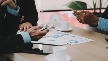 Financial analysts analyze business financial reports on a digital tablet planning investment project during a discussion at a meeting of corporate showing the results of their successful teamwork. video