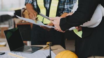 architect man working with laptop and blueprints,engineer inspection in workplace for architectural plan,sketching a construction project ,selective focus,Business concept vintage color video