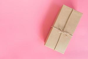 top view brown gift box for new year on pink pastel color with space. photo