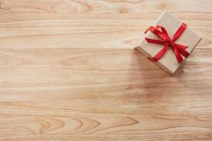 Brown gift box on wooden table background with copy space photo